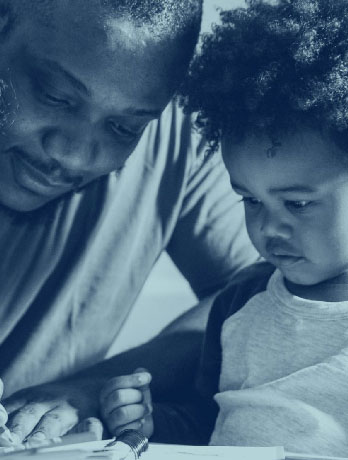 father and young son read a book