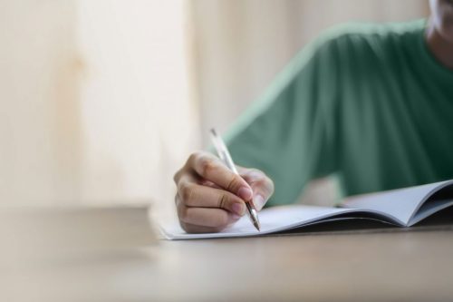 a student writes in a notebook
