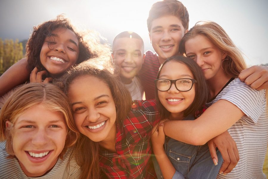 a group of student hugging outside