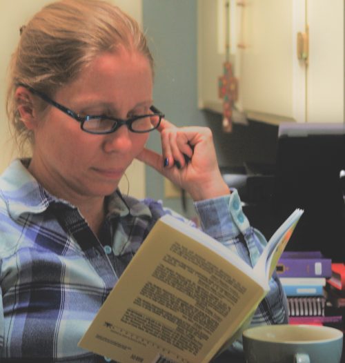 a homeschool mom reads a book